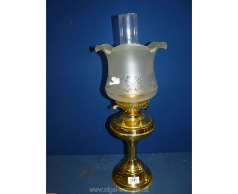 A vintage brass paraffin oil lamp having a double burner and fitted shade, in working condition. 21 1/2 " tall.