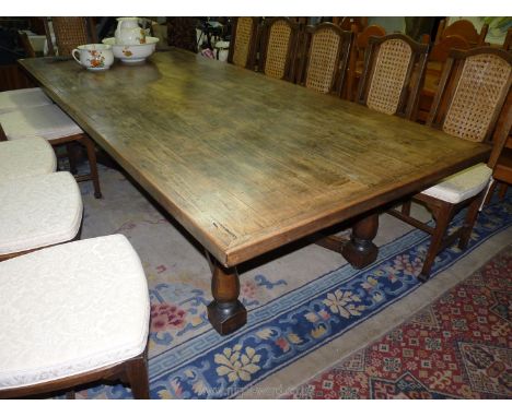 A contemporary mixed hardwoods refectory/dining Table, the lift-off/unfixed top supported on a base with turned legs united b