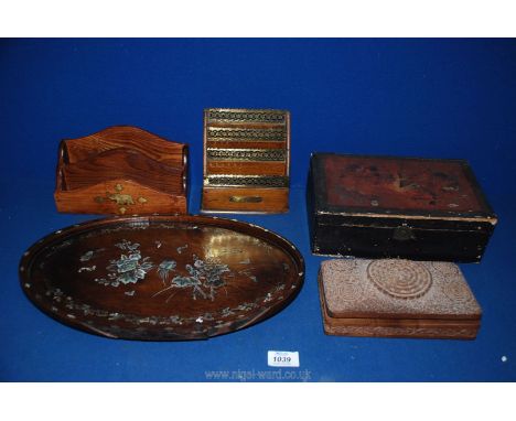 A quantity of wooden items including a mother of pearl tray, two desk tidies and two wooden boxes.