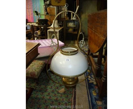 A brass ceiling oil lamp with white glass shade, 30'' tall.