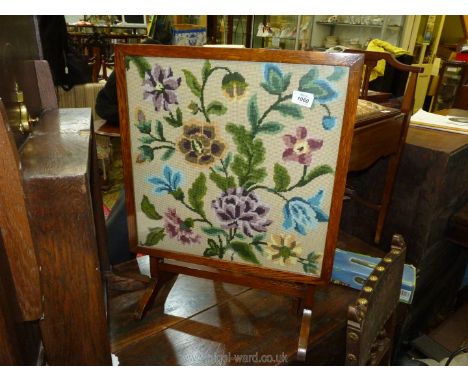 A folding side table/firescreen with floral pattern tapestry to front, 19" x 26" high.