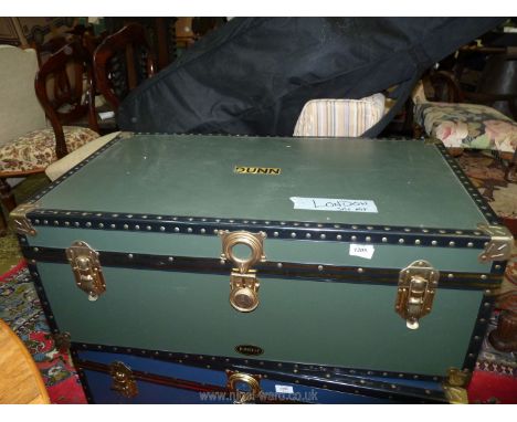 A Jonelle travel trunk in dark green with studded borders and metal corners, 36'' wide x 20'' deep x 14'' high.