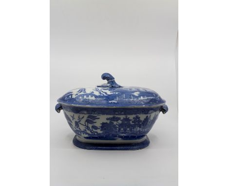 An early 19thcentury pearlware blue and white tureen, twin handled with the handle and finial fashioned as a rolling wave, th