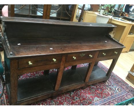 Early 18th Century three drawer oak dresser, brass handles, not original, with lower shelf and gallery top