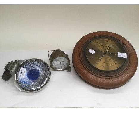 A 1920's Smiths vehicle clock. A vintage car head light NOTEK near light, Together with a barometer southall Bros and Barclay