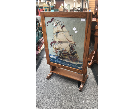 Wooden fire screen with wool work detailing a ship at sea.