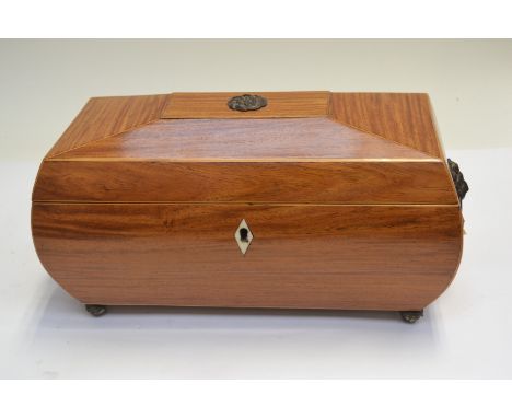 A Regency satinwood tea caddy, of bombe sarcophagus form, boxwood strung, triple division interior, brass side handles, brass