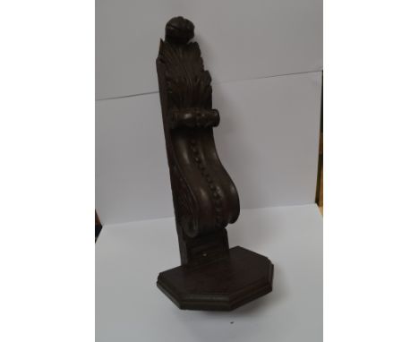 An ornate carved wooden wall bracket