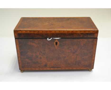 A George III amboyna tea caddy, parquetry strung, double division interior, brass ball feet&nbsp;