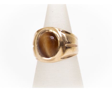 A 9ct gold and tigers eye gents ring, wide gold cand set with oval tigers eye (stone worn) size M½, total gross weight 6 gram