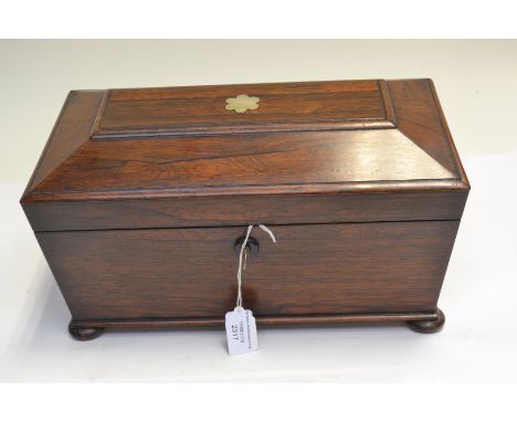 A Regency rosewood tea caddy of sarcophagus form, inlaid mother of pearl flower, side ring handles, triple division interior,