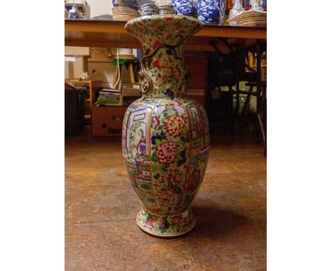 A famille rose canton vase depicting interior scenes of important family, with ladies and gentlemen conversing, serving food,