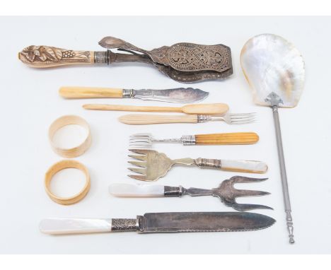 A collection of bone and ivory cutlery, pickle forks silver and a fish slice, a bone marrow spoon, with some mother of pearl 