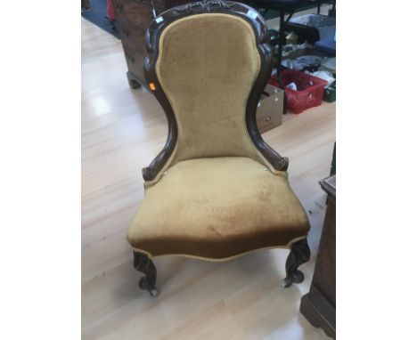 A Victorian mahogany ladies chair upholstered in gold velvet.