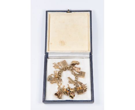 A 9ct gold charm bracelet with various novelty 9ct gold and yellow metal charms, including book crown, soldier on horseback, 