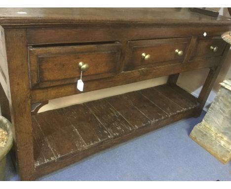 Oak three drawer dresser, 18th Century with brass handles and plank bottom shelf