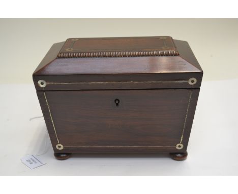 A Regency small rosewood tea caddy of sarcophagus form, side handles, bun feet&nbsp;