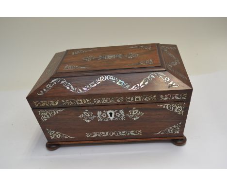 A Regency rosewood work casket of sarcophagus form, mother of pearl inlay, fitted interior, bun feet