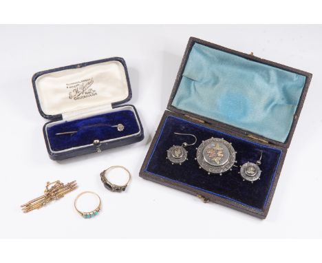 A Victorian silver target brooch and a pair of earrings en suite, applied floral leafage motifs in two colour gold, a ring se