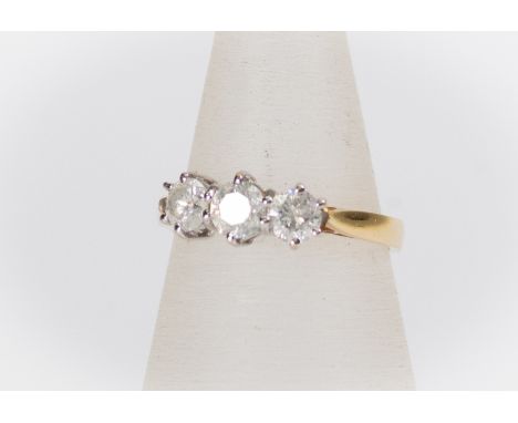 A diamond three stone ring, the three claw set round brilliant cut diamonds weighing a total of approx 1 carat, (stamped to s