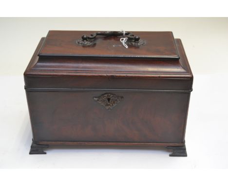 An 18th Century flame mahogany caddy top tea caddy, swing handle, four division interior, pewter bracket feet