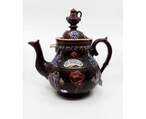 A Bargeware teapot with coffee pot finial (spout brokers but present), applied roses, Prince of Wales feathers, birds and flo