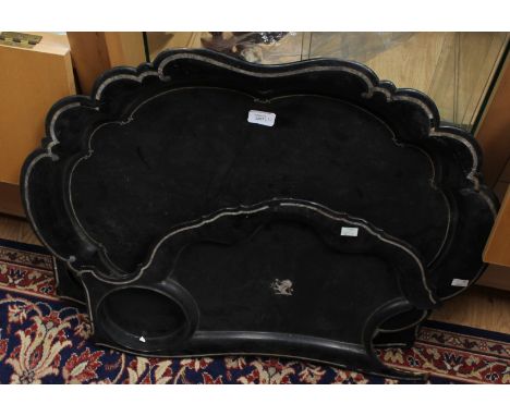 A set of three papier mache trays, a centre tray and two matching trays, with mother of pearl inlaid detail (3)