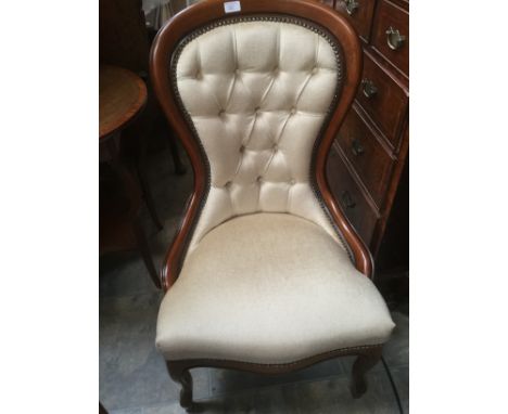 Mahogany and cream upholstered balloon back ladies chair, with button back and studded trim.