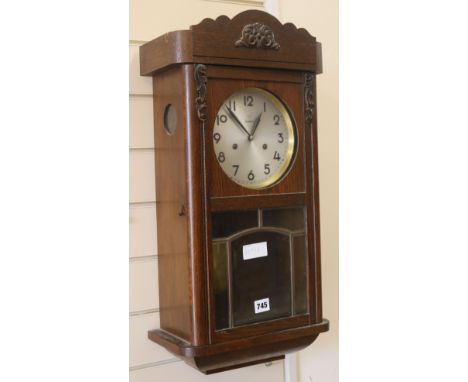 A 1930's oak wall clock, H.63cm