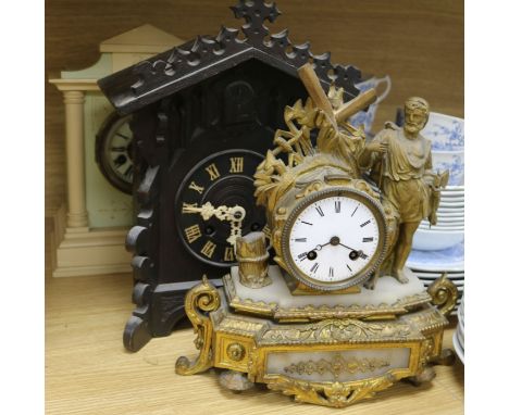 A Cuckoo clock, gilt clock and another