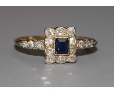 An 18ct gold sapphire and diamond tablet ring, with diamond set shoulders, size T.