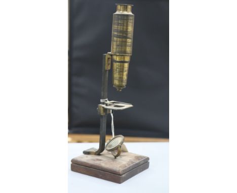 A 19th century folding sun dial and a compound microscope