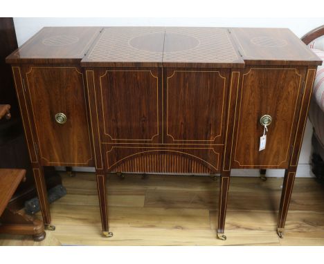 An inlaid rosewood metamorphic cocktail cabinet, in the form of a breakfront commode, W.123cm