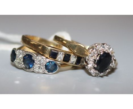 An 18ct gold, sapphire and diamond half hoop ring and two 9ct gold and gem set rings.