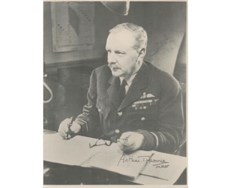 WW2 Arthur Bomber Harris signed 10 x 8 inch b/w portrait wartime image sitting at his desk in RAF uniform. Good condition. Al