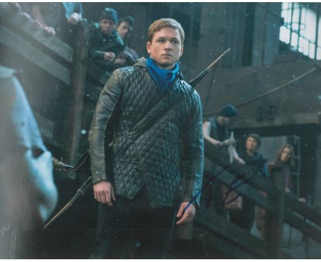 Robin Hood actor Taron Egerton signed 10 x 8 inch colour with bow and arrow. Good condition. All autographs come with a Certi