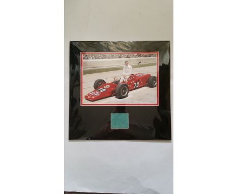 MOTOR SPORT, signed piece by Graham Hill, overmounted beneath colour photo of him with his red Lotus, 15.5 x 15.25 overall, E