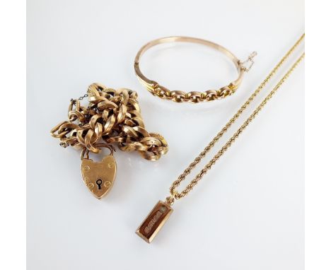 A 9ct gold ingot pendant, suspended on 9ct gold rope twist chain, together with a yellow metal hollow link bracelet, stamped 