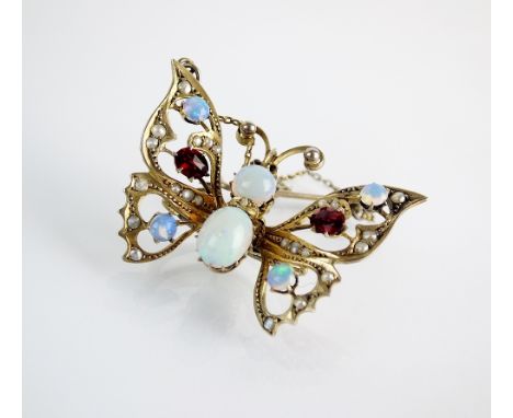 An opal, seed pearl and red stone set butterfly clip, all claw set in gilt metal with later safety chain, the clip stamped 'A