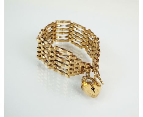 A 9ct gold six bar gate link bracelet, with heart shaped padlock clasp and attached safety chain, hallmarked 1976, weight 13.