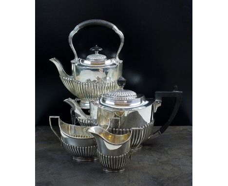 An Edwardian four piece silver tea service, Fordham & Faulkner, Sheffield 1906, each piece of oval half reeded form, comprisi