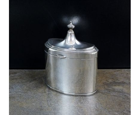 A Goldsmiths and Silversmiths silver tea caddy, London 1924, of plain polished oval from with urn finial to the hinged cover,