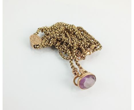 A yellow metal guard chain, the swivel stamped '9c', suspending an oval mixed cut amethyst fob, total weight 29.5gms