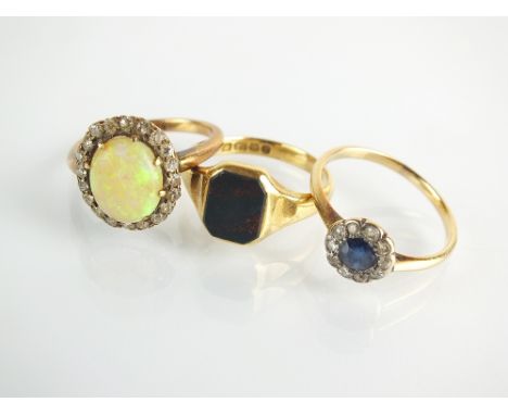 An 18ct gold bloodstone signet ring, size L, together with an opal and white stone cluster ring, stamped '18ct' and a sapphir