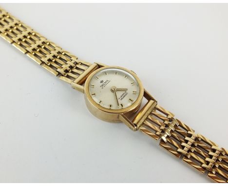 A Lady's 9ct gold Delma of Switzerland wristwatch, the circular silvered dial with batons, manual wind, with attached 9ct fac