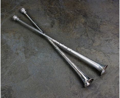 A pair of silver hunting horns, marks rubbed, London, each of tapering segmented form and 30.5cm long, total weight 2.4oz (2)