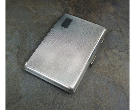 A silver cigarette case, W H Manton Ltd, Birmingham 1950, of rectangular engine turned form with silver gilt interior, 12.5cm