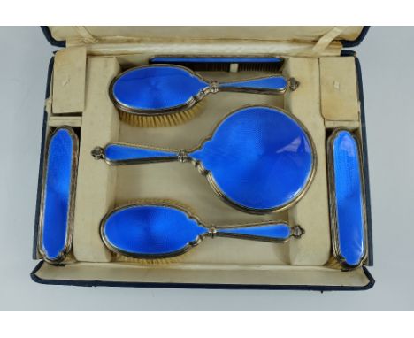 Silver and blue enamelled ladies brush set , London 1923, comprising brushes, comb and vanity mirror in original silk lined b