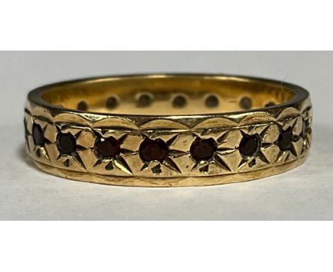 A 9ct gold eternity ring, set with ruby chips, size P, 3.1g gross