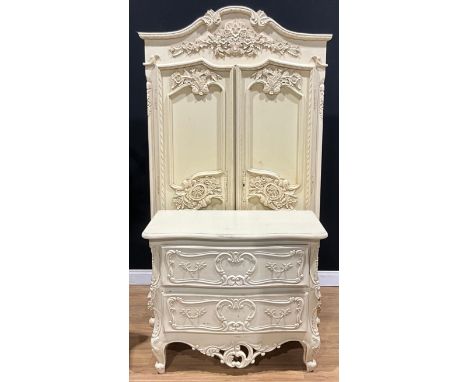 A contemporary French provincial style armoire or wardrobe, 202cm high, 114cm wide, 58cm deep; a similar commode, 81cm high, 